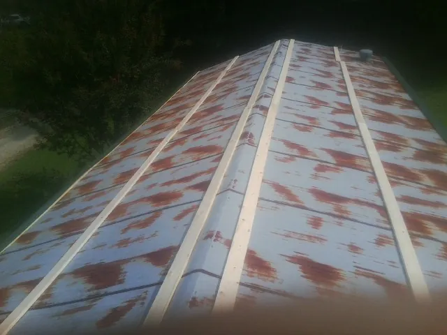 Rusted metal roof panels with new wood purlins before replacement — Storm Damage Roof Repair in Ridgeland by Roofing Brothers
