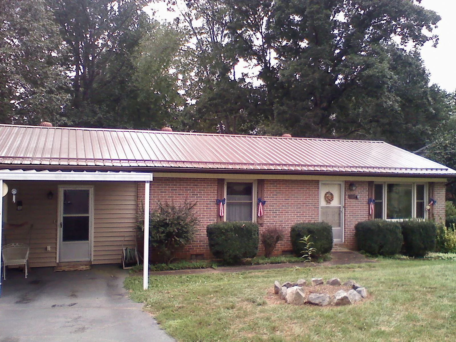 Bronze metal roof and carport on a brick ranch home — Roof Repair work by our crew in Ridgeland